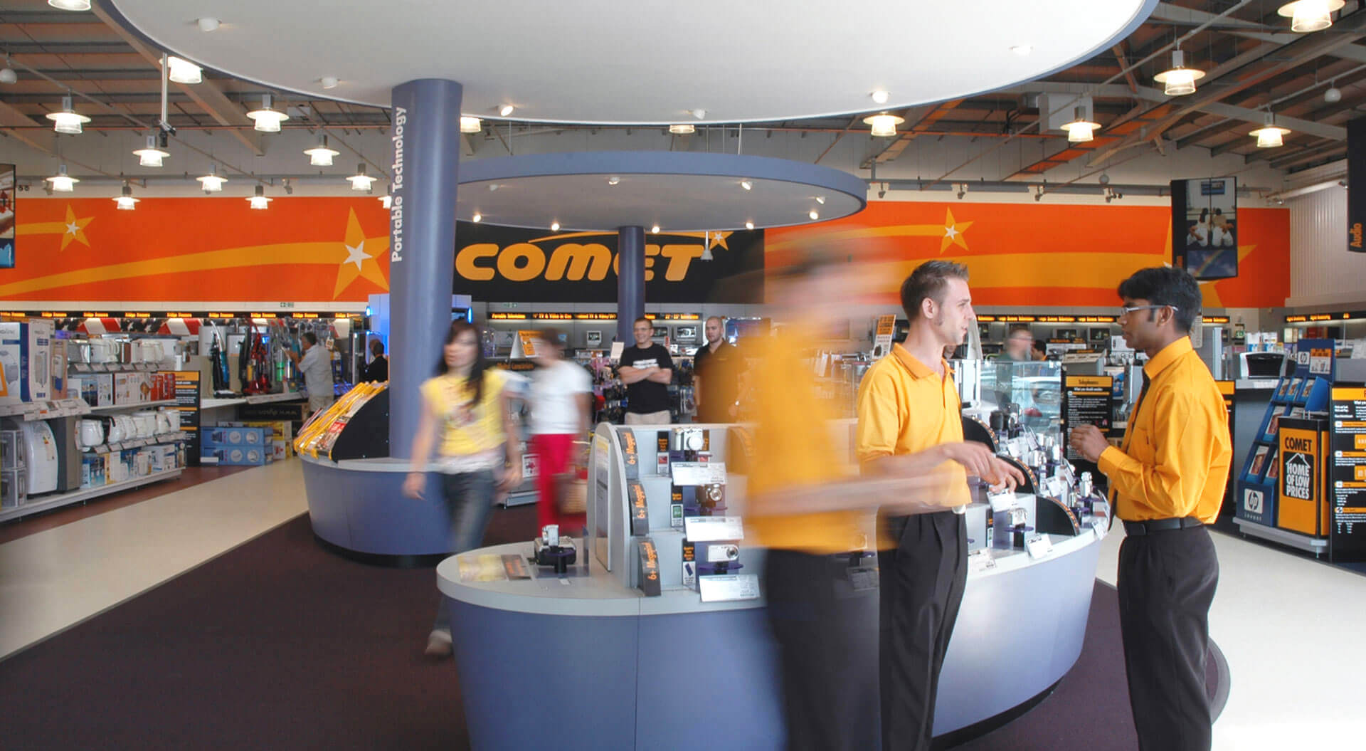 Comet electronic and technology reatil store design merchandising systems Comet Technology Store rebrand identity, interior design digital camera merchandising display and super graphic wall communication