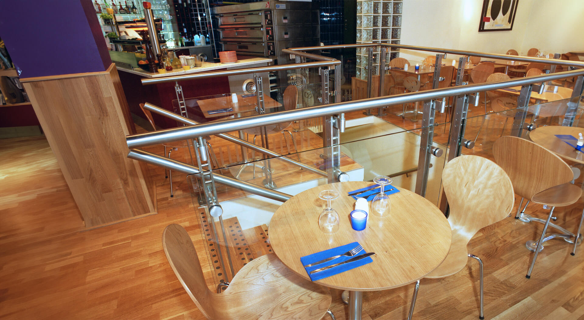 Caffe Piazza restaurant staircase design Caffe Piazza restaurant table and seating next to staircase design