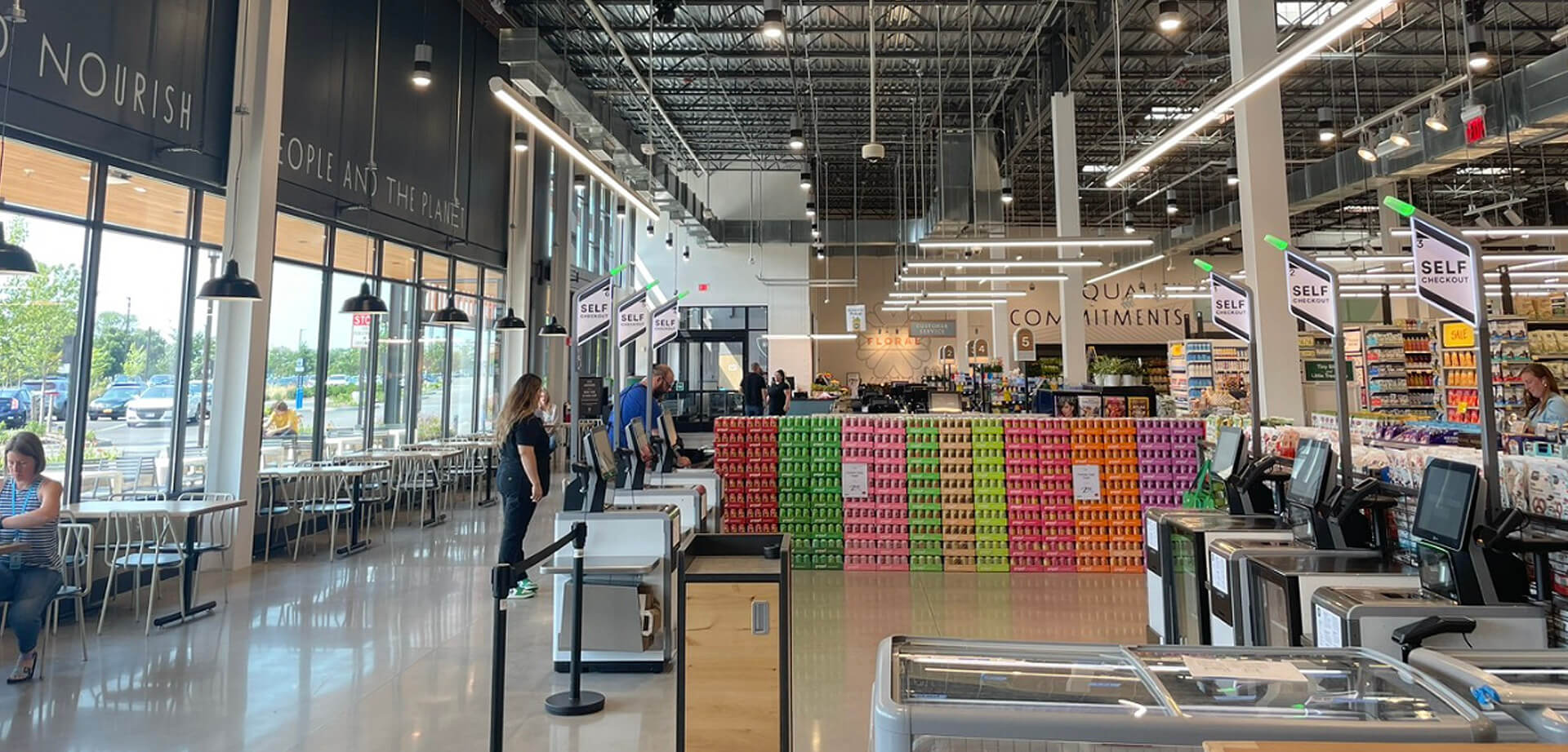 Whole Foods Market grocery store - Huntington Station, New York. The store features self-checkout lanes and a dining area.