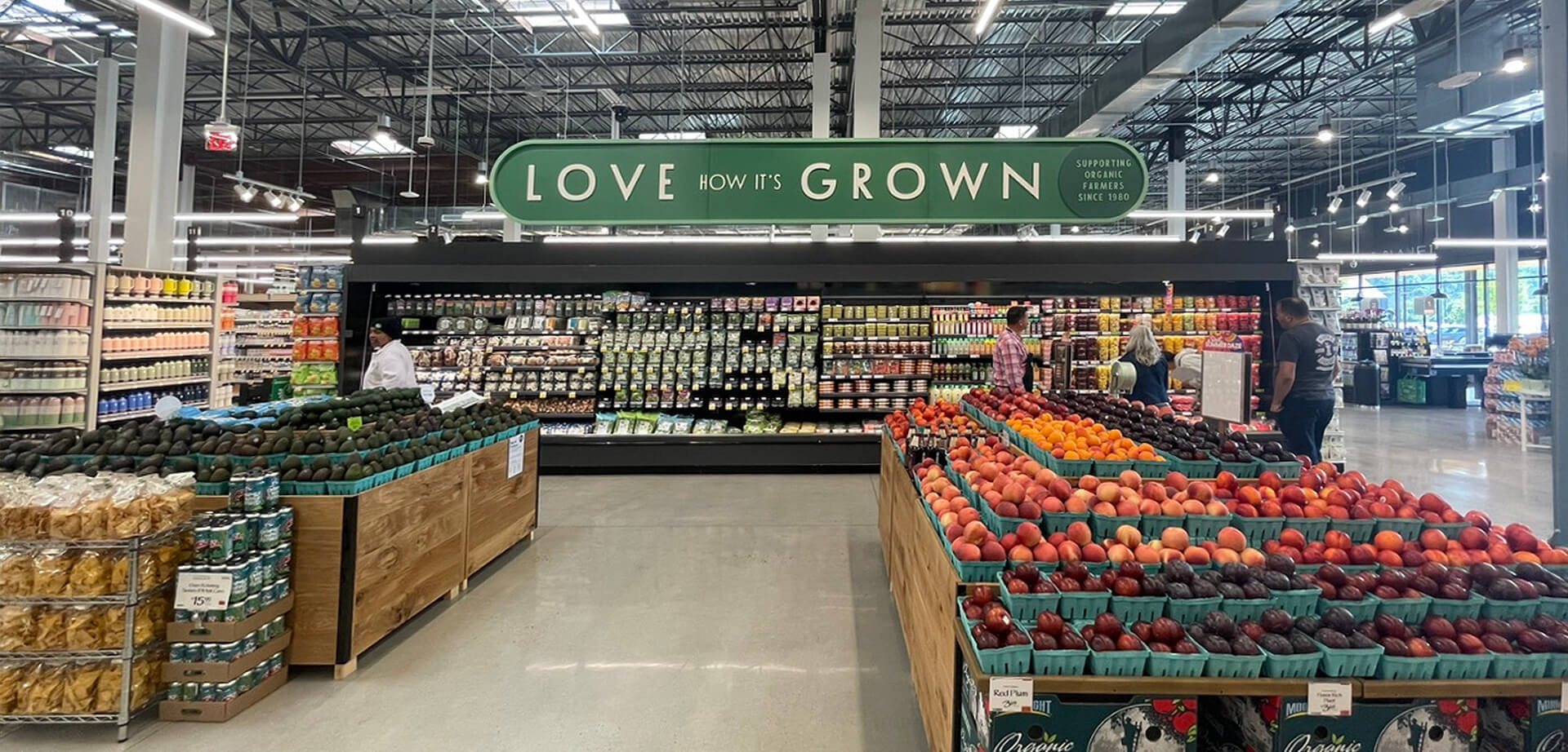 Whole Foods - The text on the sign above the refrigerated section reads "LOVE HOW IT'S GROWN".