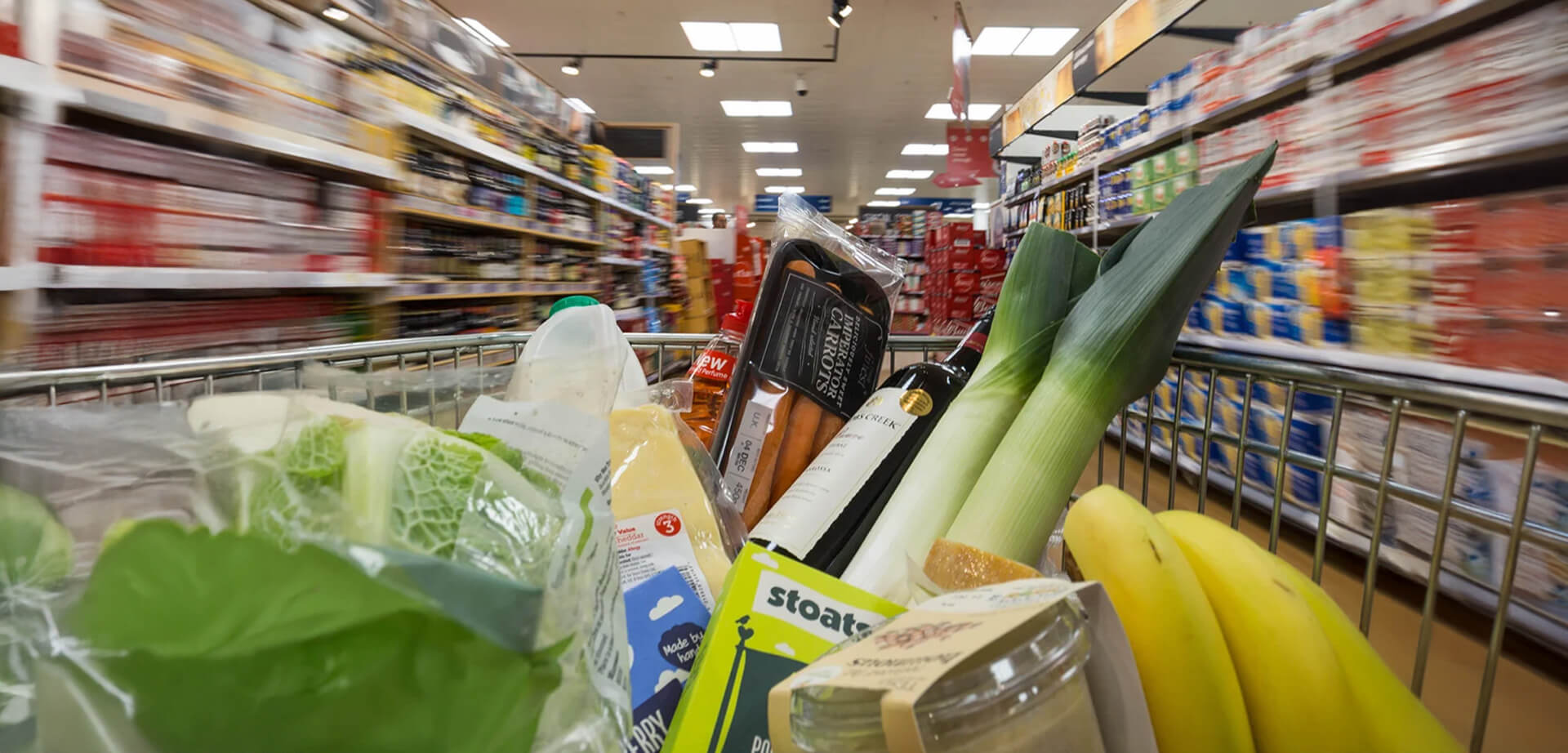 Tesco Express store in Holborn, London. Shopping trolley full of products.