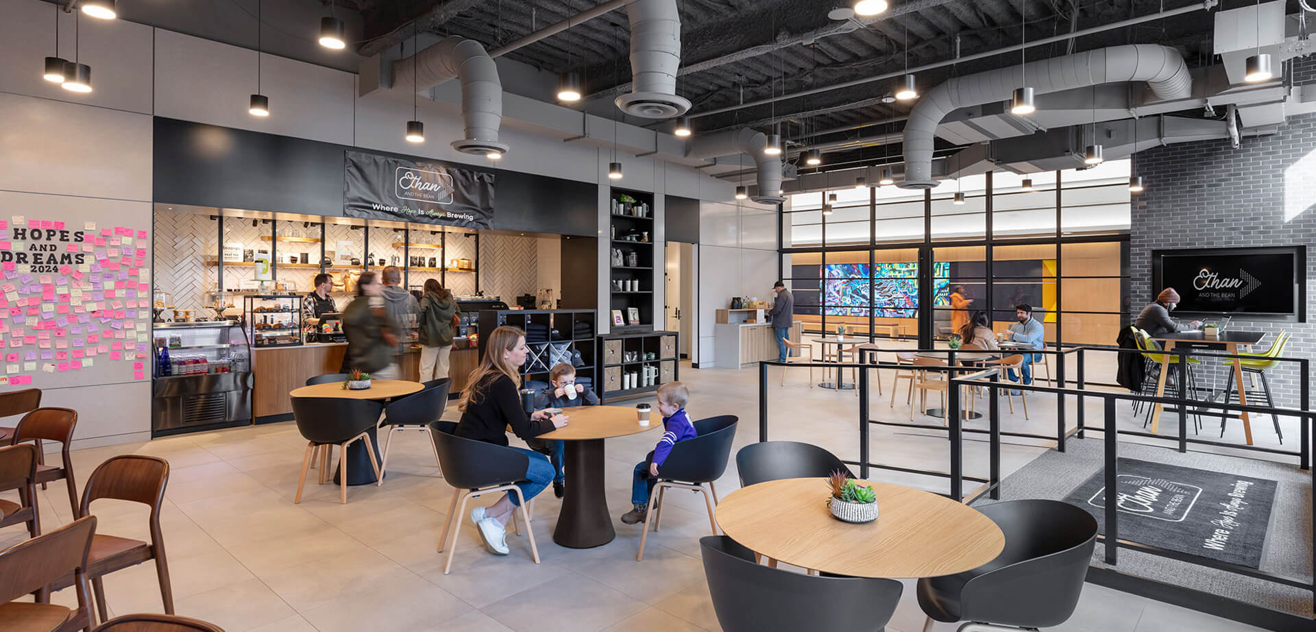 The interior of the Ethan & The Bean café located in the lobby of the Valley Bank headquarters building in Morristown, New Jersey. The café is a non-profit organization dedicated to a social mission: to increase the employment rate for individuals with intellectual and developmental disabilities (IDD) by providing job readiness training and an empowering work environment. The phrase "HOPES AND DREAMS" visible on the wall relates to this mission, a place "Where Hope Is Always Brewing"