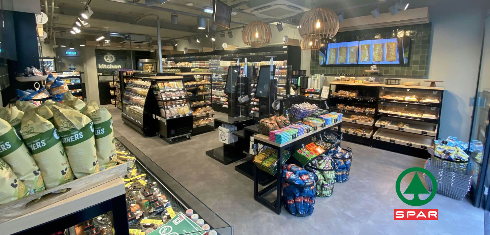 The design is a modern, urban concept, likely one of the smaller "SPAR city small" stores first trialed in the Netherlands.