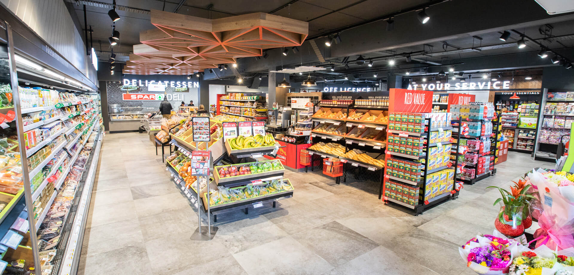 Spar Deli convenience store. The store layout emphasizes fresh produce, a deli counter, and "food-to-go" options.