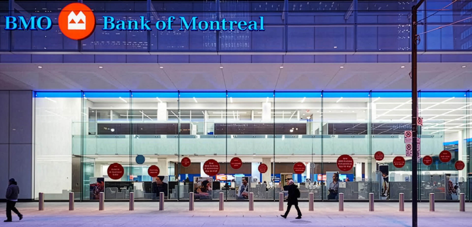 The image shows the prominent main branch of the Bank of Montreal (BMO), situated at First Canadian Place in the heart of Toronto's Financial District.