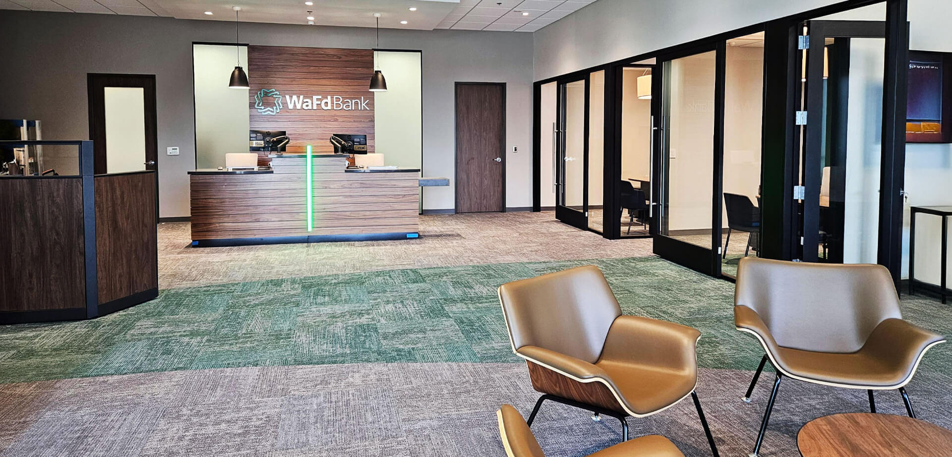 The image showcases WaFd's updated architectural concept designed to create a more open, transparent, and approachable banking experience, shifting away from traditional high-barrier teller lines.