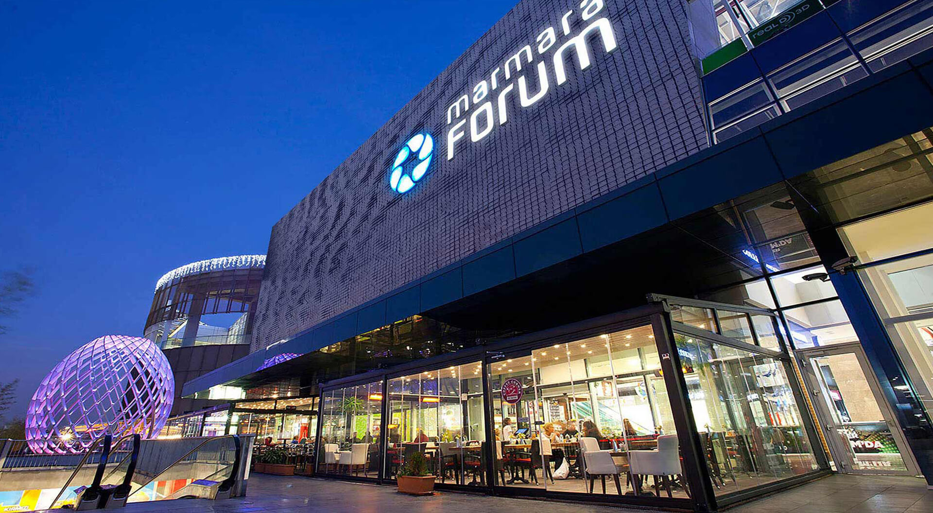 The exterior facade, branding  and outdoor dining area of the Marmara Forum shopping centre located in the Bakırköy district of Istanbul. Turkey