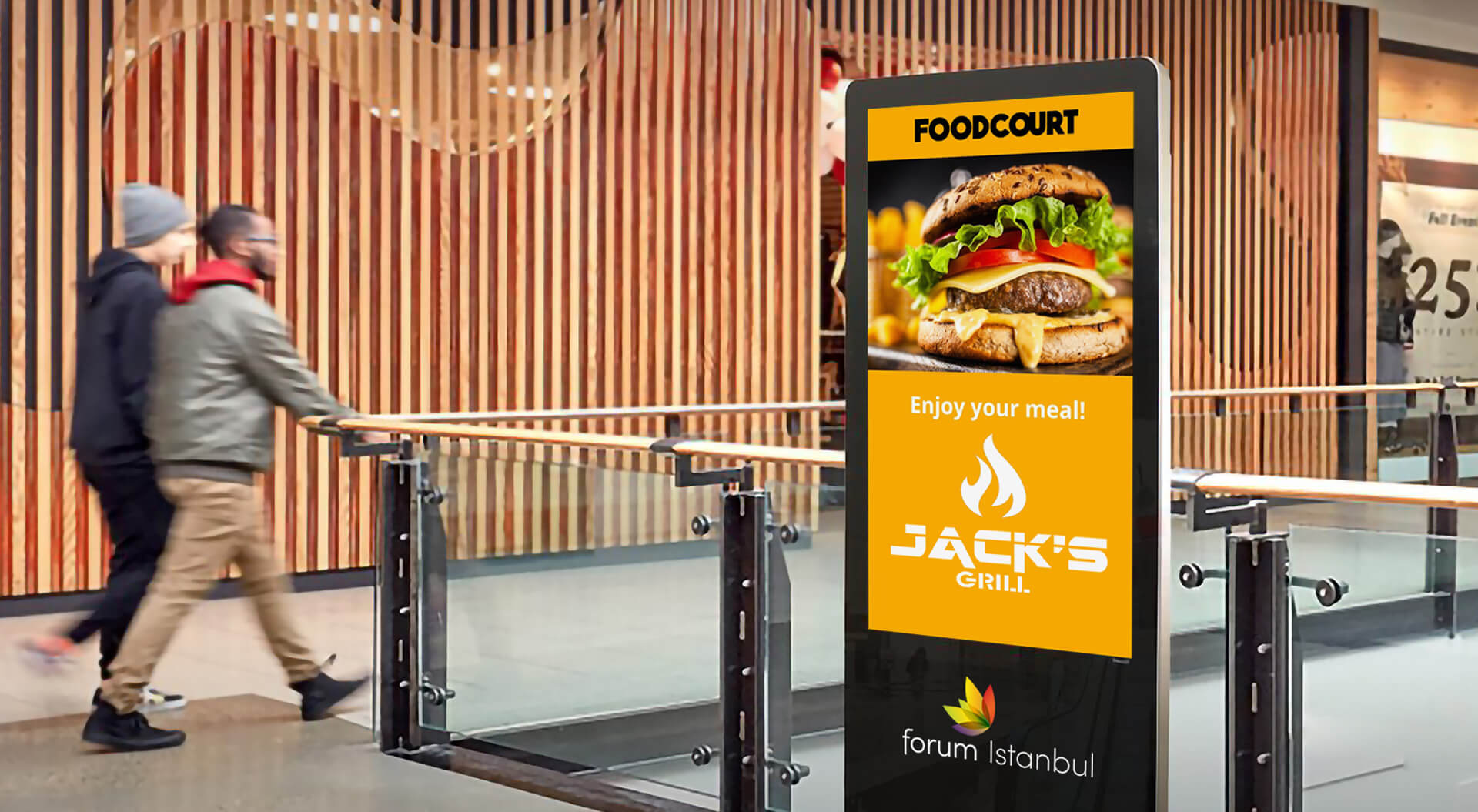 This image shows a person using an interactive digital wayfinding kiosk inside the Marmara Forum shopping mall.
